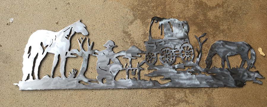 Tammy's metal art of horses, a carriage and a person 
